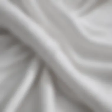 Close-up view of fabric textures used in all white club dresses.