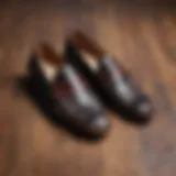 Stylish plaid loafers on a polished wooden surface